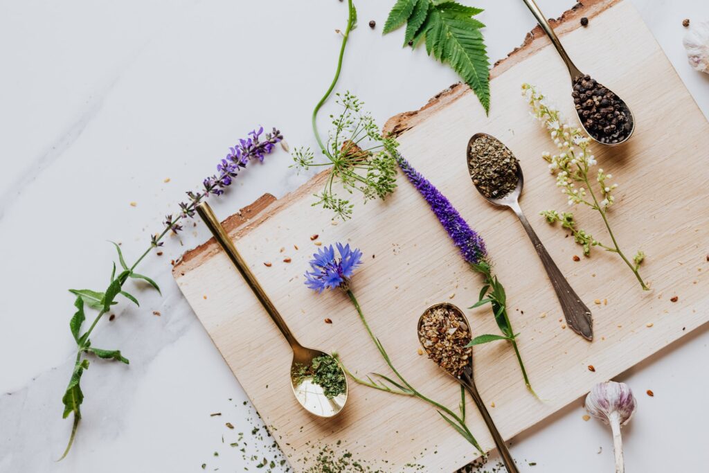 Edible Flowers and Spices on Wooden Board